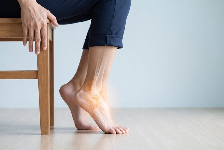 Sitting on the edge of a chair and lifting both heels, the arch rising on the inner side of the foot.